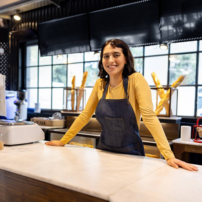 Woman Behind Counter at Pastry shop