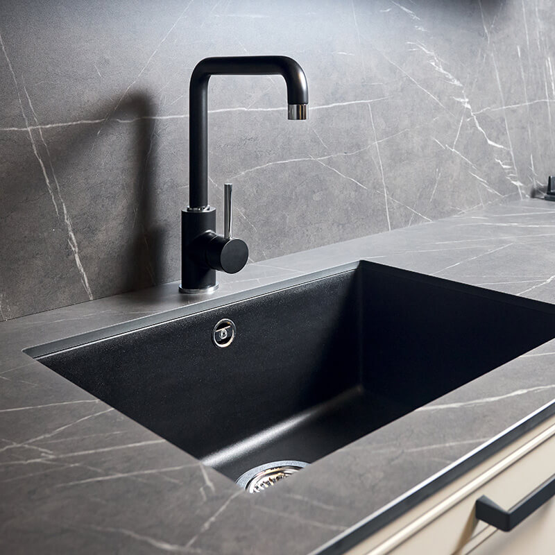Kitchen sink area with black square matte sink tap in contemporary style