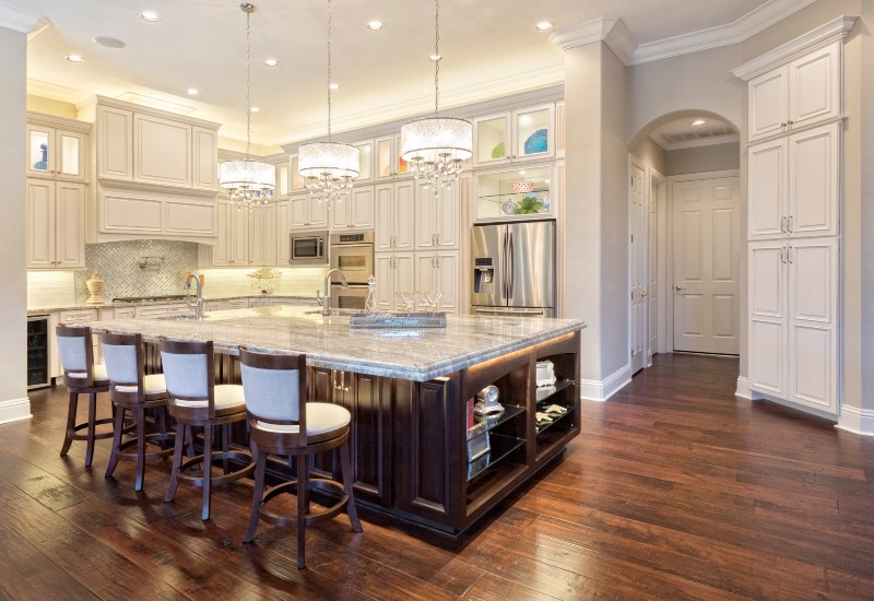 A spacious kitchen featuring a center island with custom countertops in the Greater Orlando Area