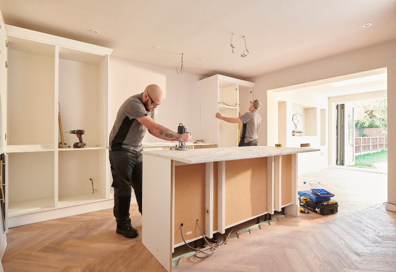 Two men working together to install new countertops in a home kitchen in the Greater Orlando Area